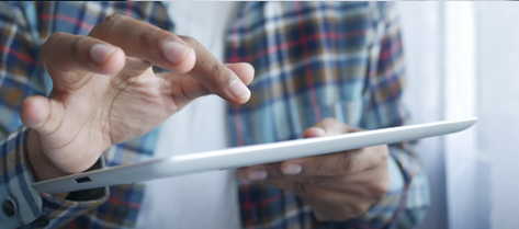 Man using tablet to view case studies