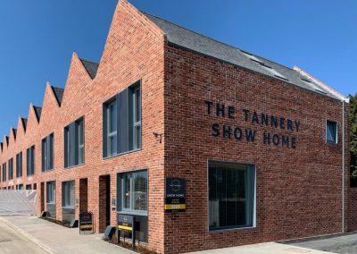 Row of new build houses in red brick on a clear day