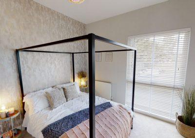 Bedroom within new build house with four poster bed