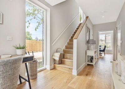 Hallway of new build, light with smooth white walls and laminate flooring
