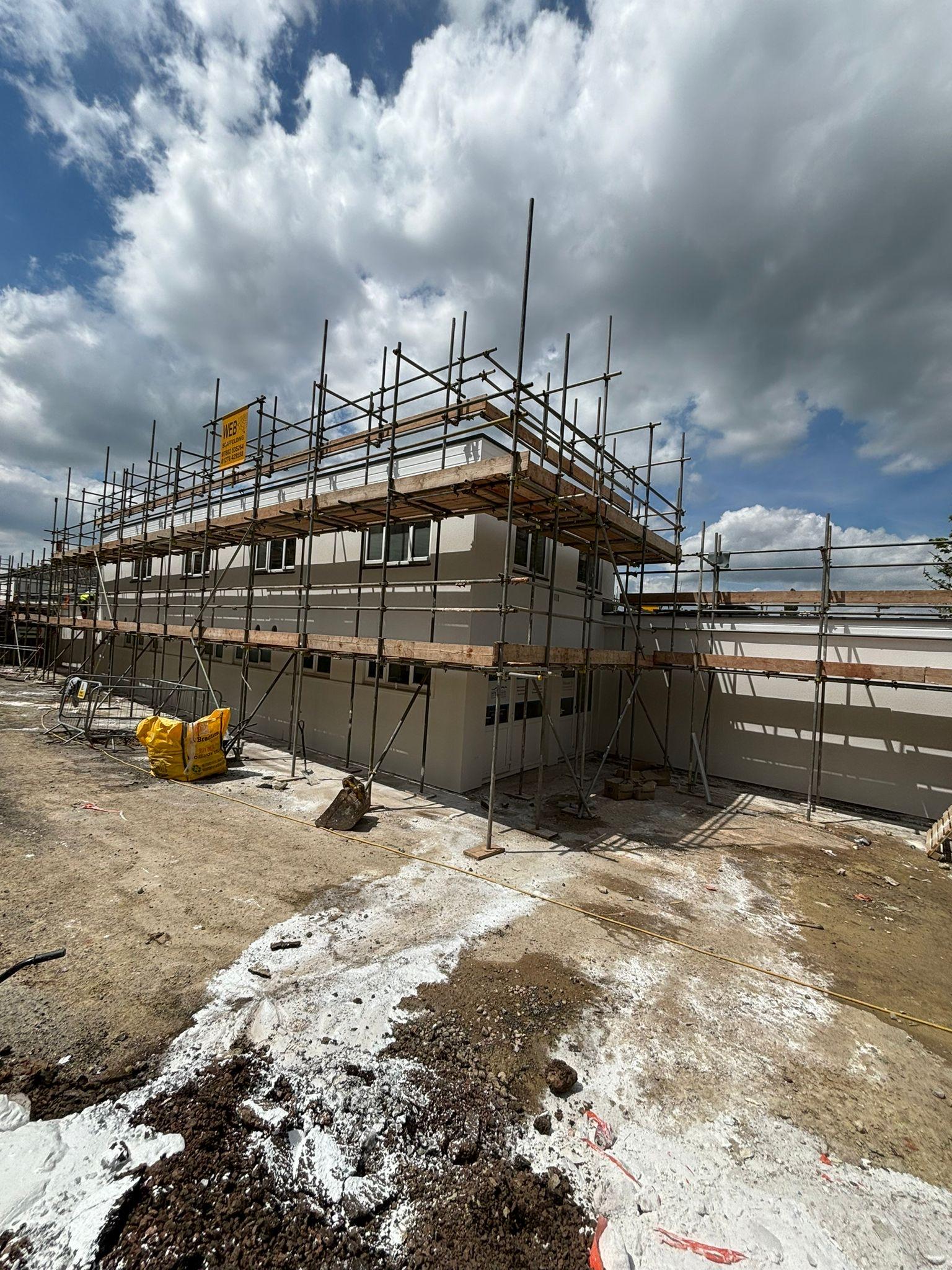 Scaffolding around a white building