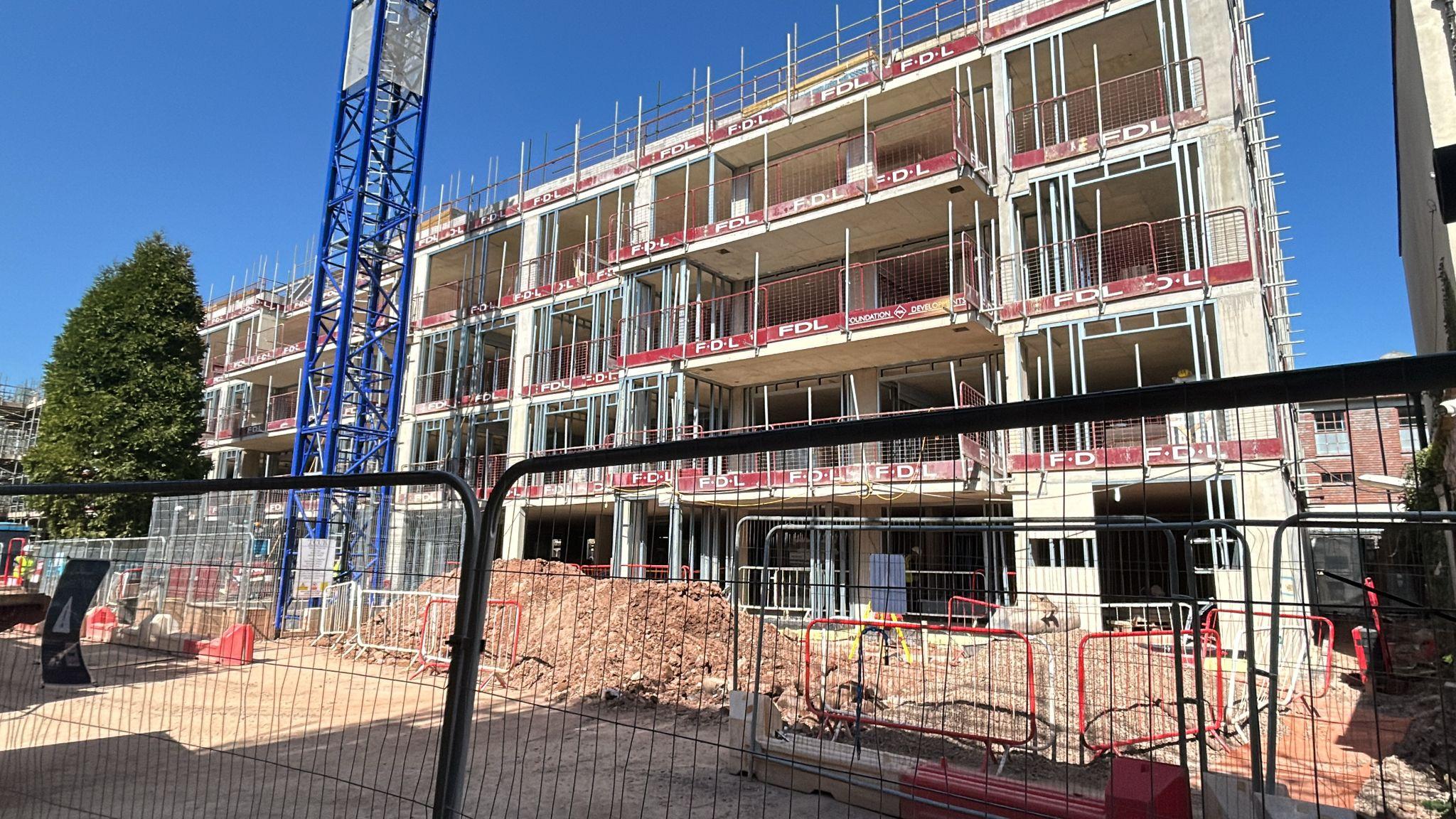 During construction image of housing development of multiple dwellings