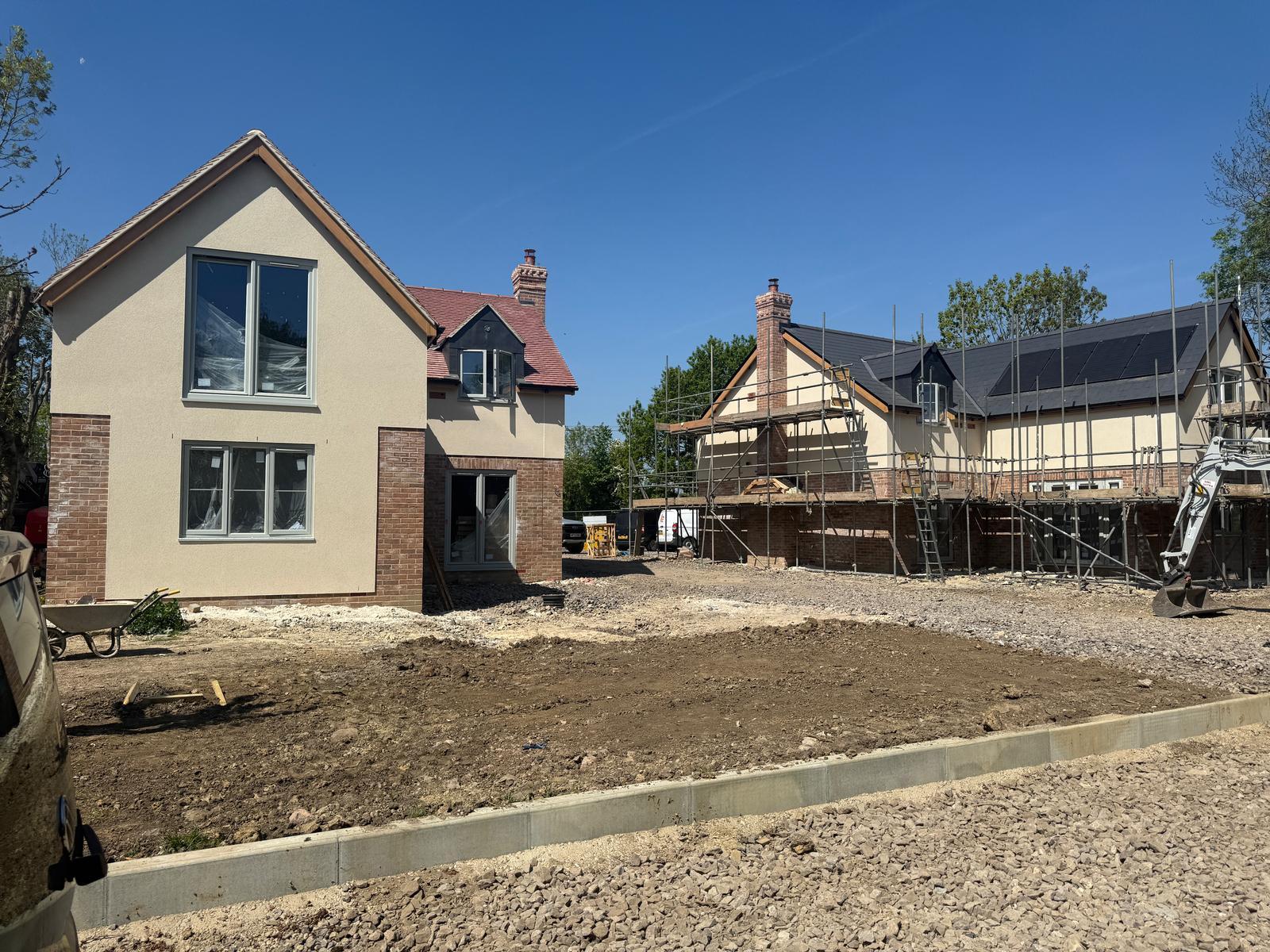 Detached new build property with render and brickwork, red tiled roof alternative angle