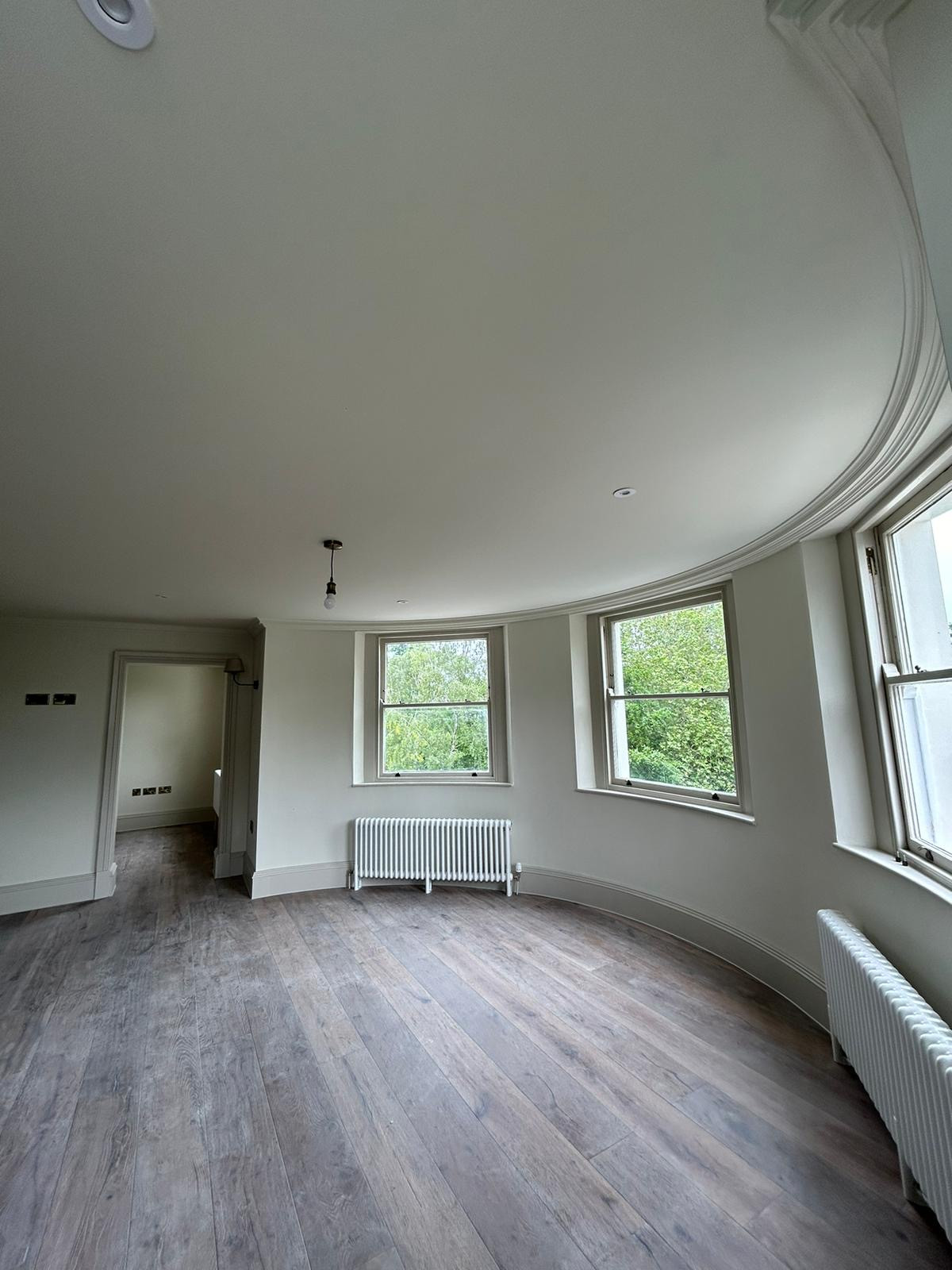 Fresh walls on display within a curved room with windows