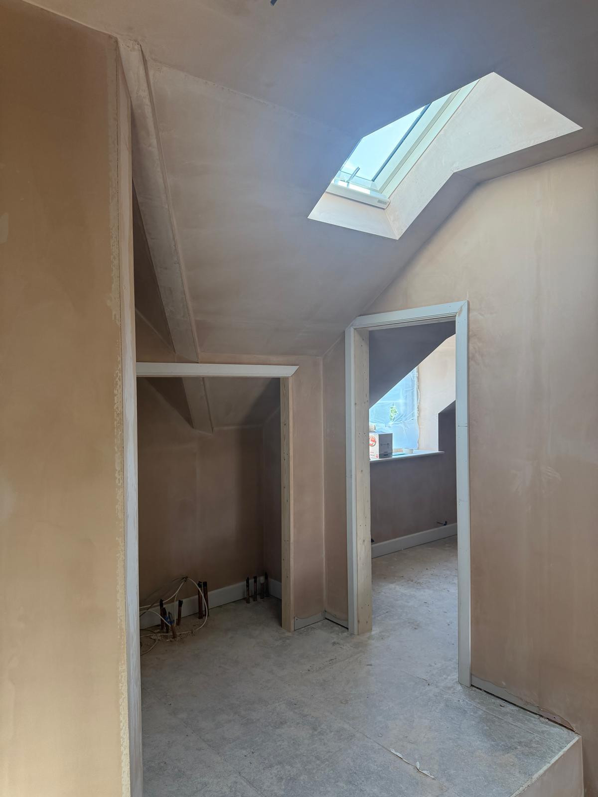 Fresh plaster within hallway with doorways and roof lights