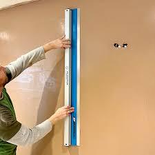 Man smoothing fresh plaster on wall